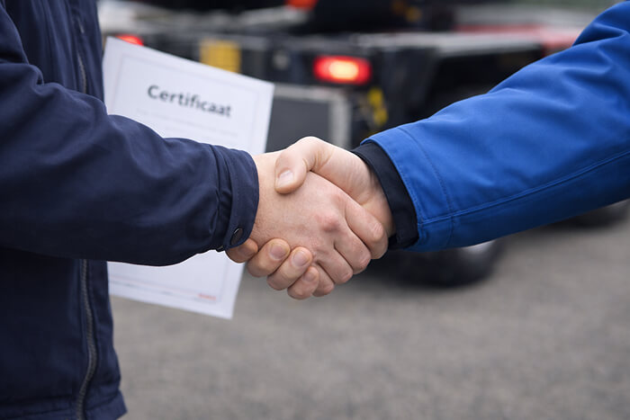 Handshake symbolising success, with a visible certificate confirming completion of the training.